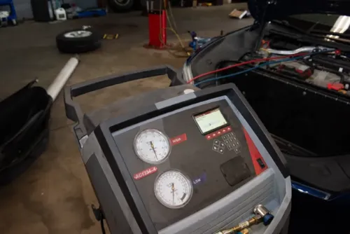AC service machine connected to vehicle inside Epoch Automotive garage in Doylestown, PA