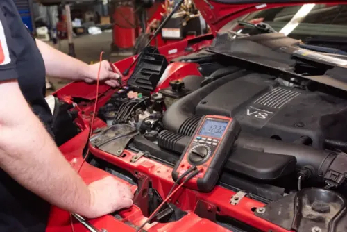 Epoch technician checking voltage on a red V8 engine vehicle in Doylestown, PA
