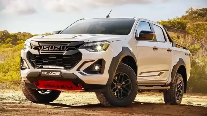 White Isuzu D-Max Blade 4x4 truck parked on a dirt trail in sunny terrain