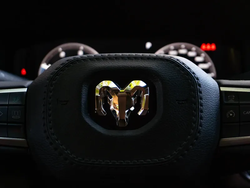 Close-up view of a RAM vehicle steering wheel with dashboard in background
