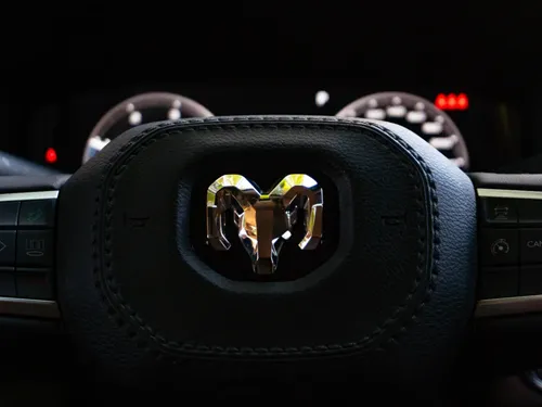 Close-up view of a RAM vehicle steering wheel with dashboard in background